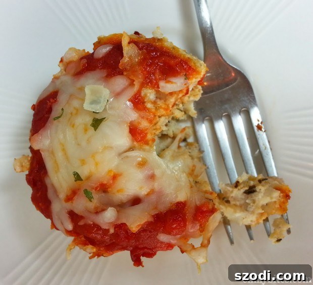 Baked Chicken Parmesan Meatloaf Muffins garnished with fresh herbs