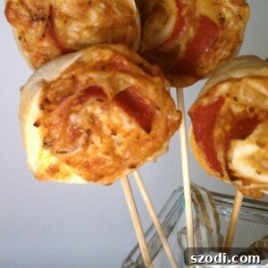 Three golden brown pizza on a stick appetizers