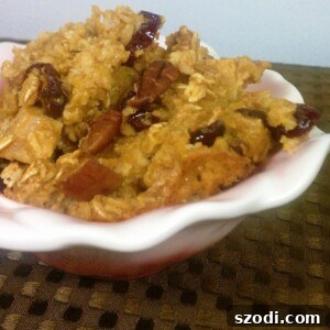 A slice of golden-brown Pumpkin, Cranberry & Apple Baked Oatmeal on a white plate, ready to be enjoyed.
