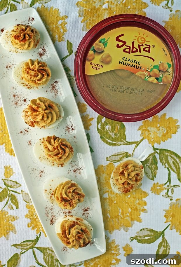 Serving plate with Hummus Deviled Eggs, garnished with paprika