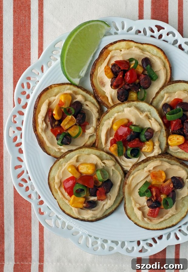 Close-up of a platter of individual Fiesta Potato Rounds, showcasing the vibrant toppings and crispy potato base.