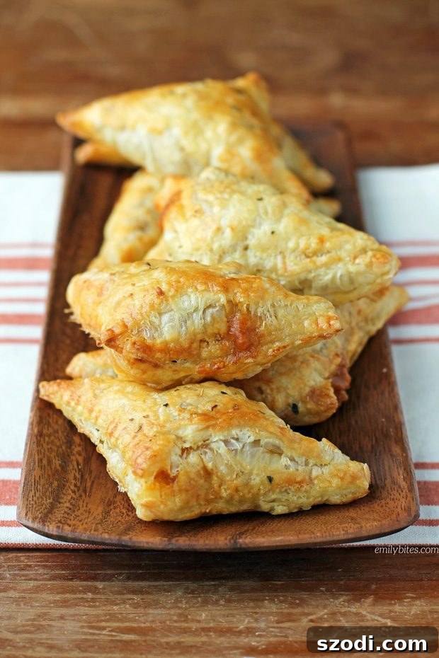 Close-up shot of a Taco Puff Pocket cut in half, showing the beef, cheese, and tomato filling