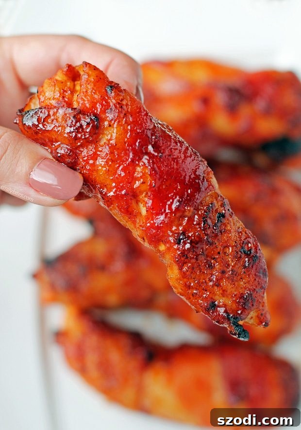 Crispy Bacon BBQ Chicken Tenders 2 Barbecue Bacon Wrapped Chicken Tenders - Juicy chicken tenders wrapped in crispy bacon, glazed with barbecue sauce