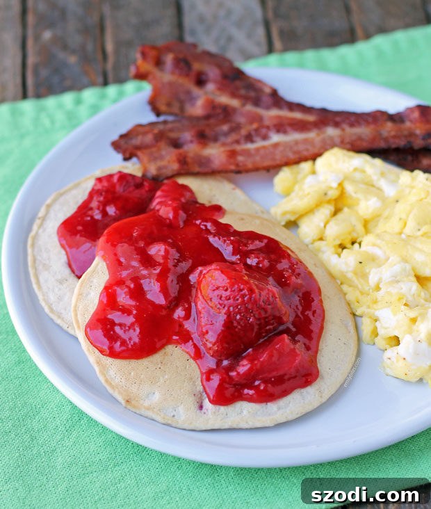 Strawberry Almond Cream Pancakes with eggs and bacon