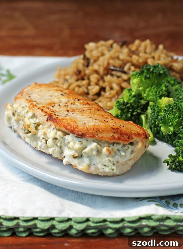Delicious Cream Cheese and Herb Stuffed Chicken, golden brown and perfectly seared, ready to be served.