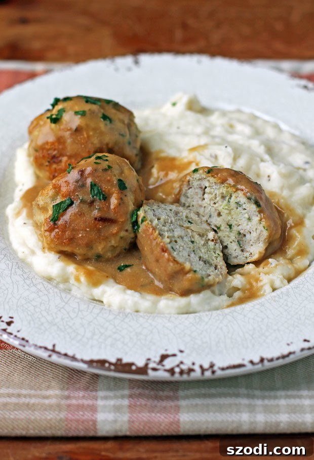 Cross-section of Swedish Turkey Meatballs on a plate, showing the tender interior and rich gravy