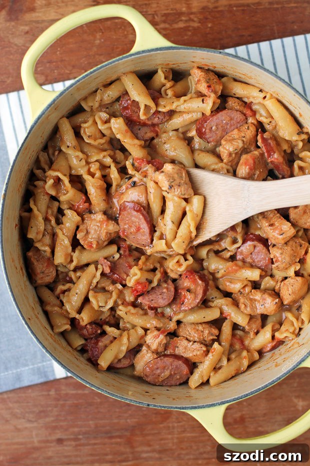 One-Pot Cajun Chicken and Sausage Pasta simmering in a large pot on the stove.