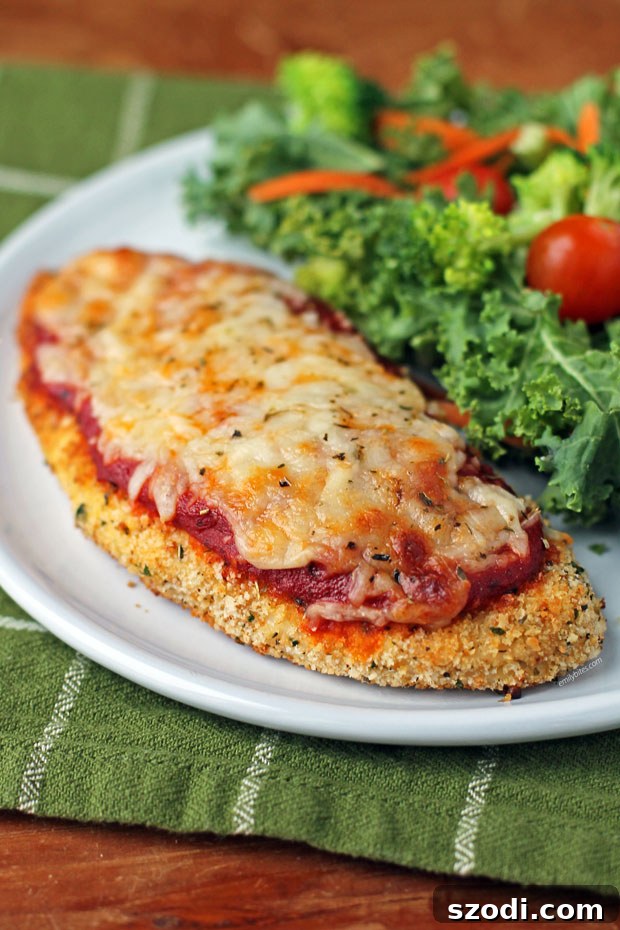 Delicious Crispy Chicken Parmesan on a plate ready to be served, topped with marinara sauce and melted mozzarella.