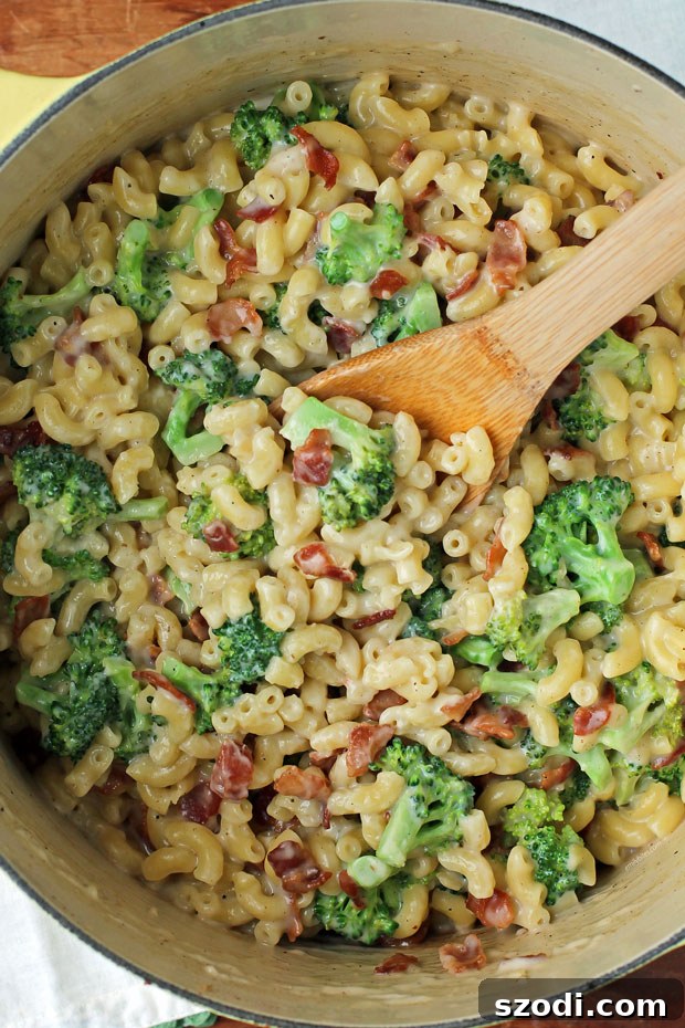A hearty pot of One-Pot Bacon Broccoli Mac and Cheese, freshly cooked and steaming.