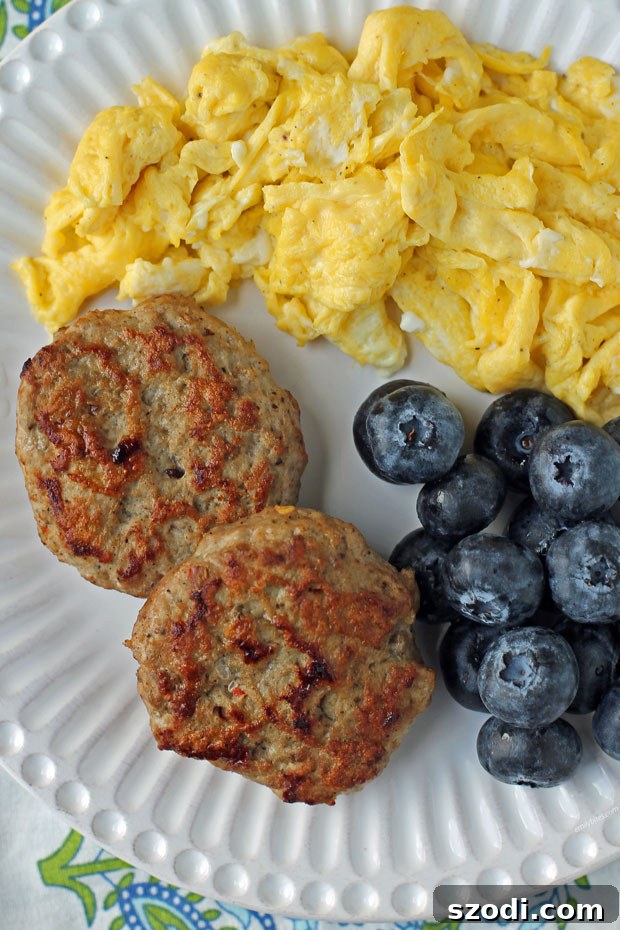 Savory turkey breakfast sausage patties served alongside scrambled eggs, perfect for a healthy breakfast.