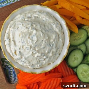Creamy Veggie Dip beautifully garnished with fresh herbs, surrounded by colorful vegetables, ready to serve