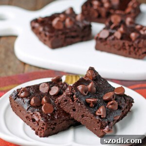 Fudgy Pumpkin Chocolate Brownies on a plate, showing the rich texture and topping.