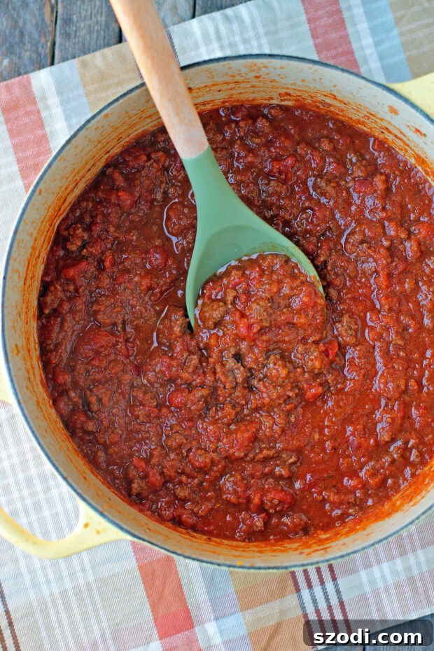 Weeknight Bolognese sauce simmering in a pot, rich and hearty