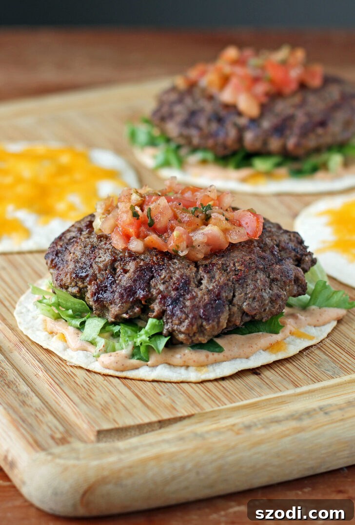 Quesaburger 2 Quesadilla Burgers open on a cutting board