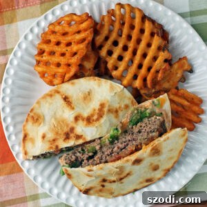 Quesaburger 6 Quesadilla Burger with fries on a plate