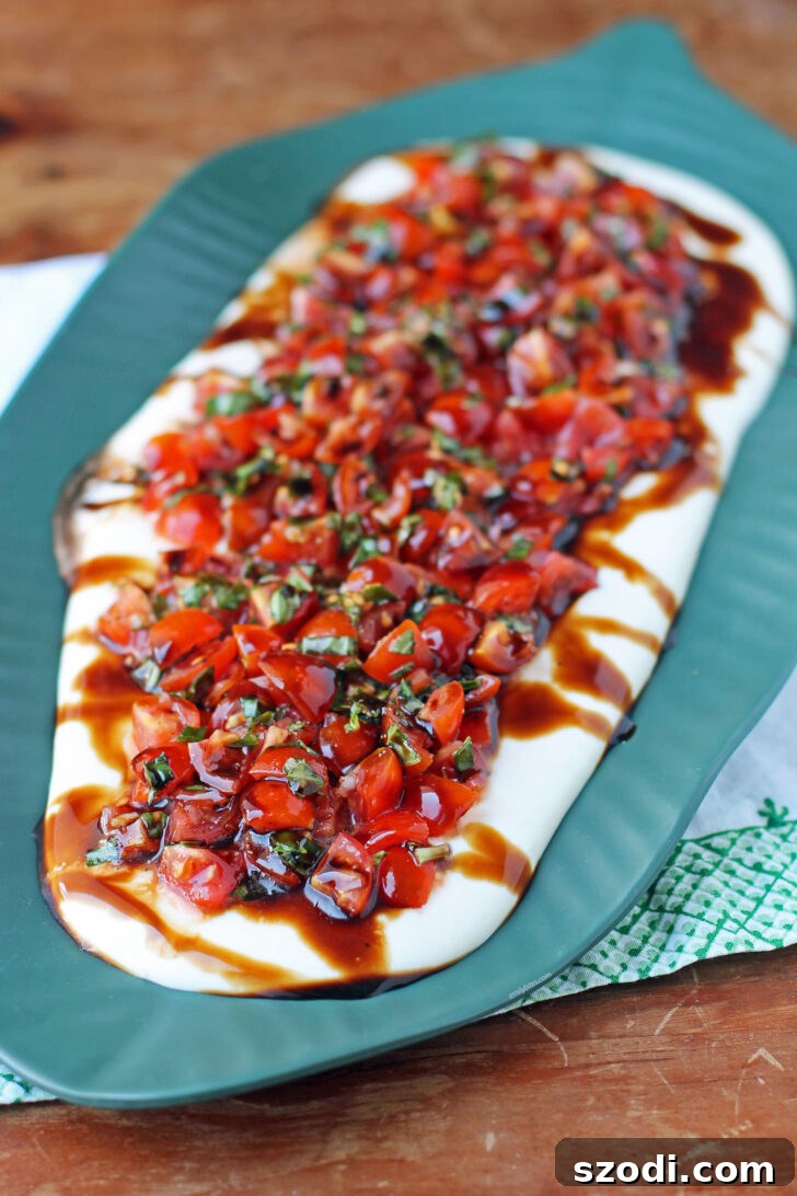 Creamy Whipped Feta Bruschetta Dip garnished with fresh basil, ready to be served