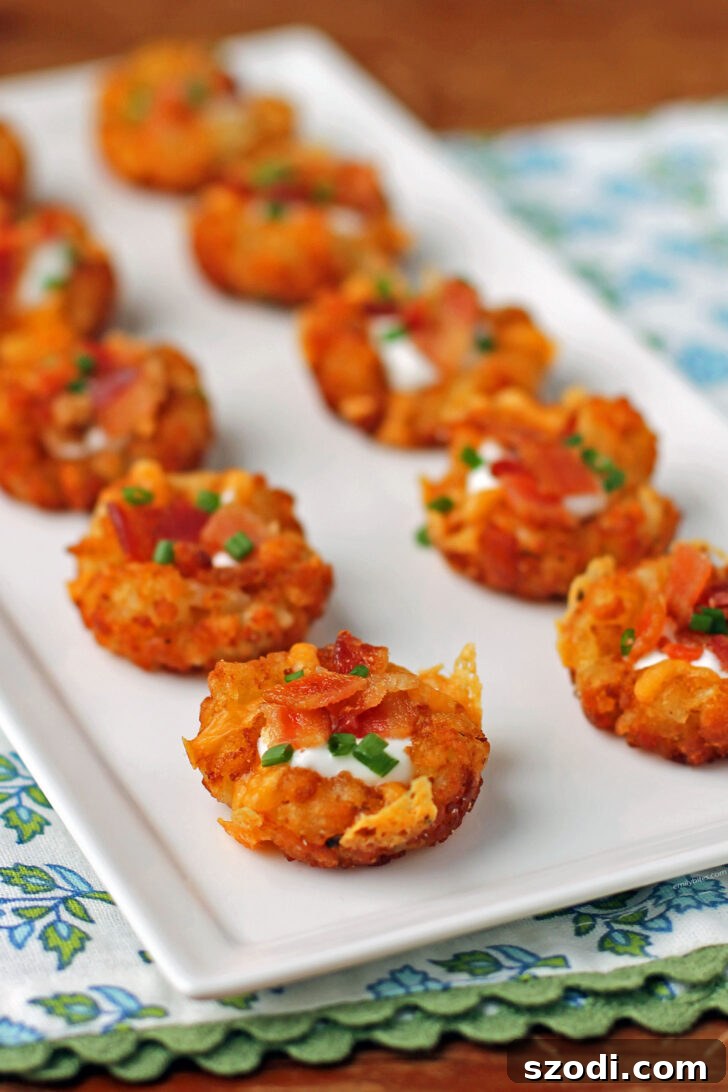 Delicious Mini Loaded Tater Tot Cups on a serving platter, perfect for parties and gatherings.