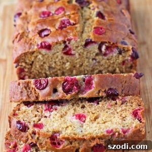Orange Cranberry Bread sliced on a cutting board