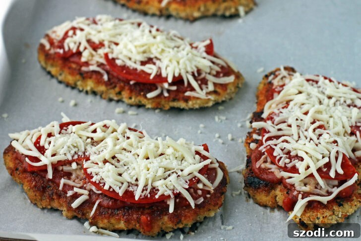 Chicken Pizzesan ready to bake on a baking sheet