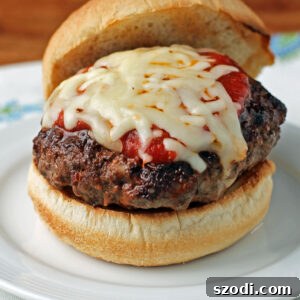 A perfectly cooked Stuffed Pizza Burger resting on a plate, ready to be served.