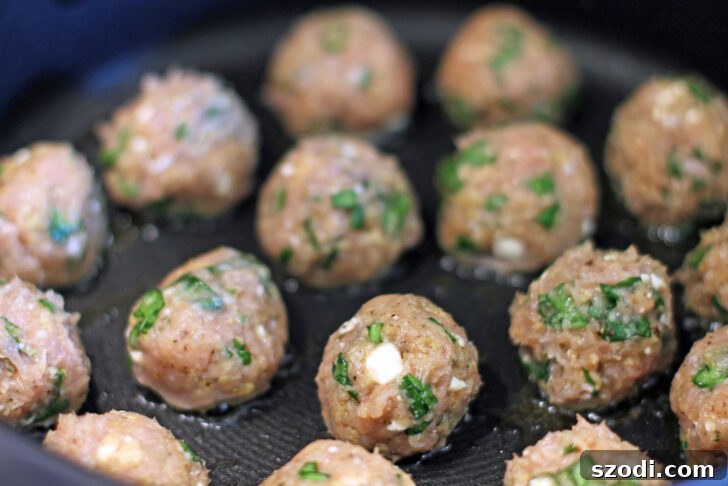 Uncooked Greek Chicken Meatballs ready for cooking in a pan